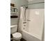 Cozy bathroom features a bathtub, shower head, and shelving for storage solutions at 1634 Hurdle Mills Rd, Roxboro, NC 27574