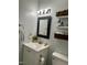 Updated bathroom featuring modern vanity, mirror, and lighting at 1634 Hurdle Mills Rd, Roxboro, NC 27574