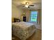 Bedroom features a patterned bedspread, neutral colors, and natural light at 1634 Hurdle Mills Rd, Roxboro, NC 27574