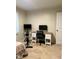 Bedroom features a workout bike and a desk with computer at 1634 Hurdle Mills Rd, Roxboro, NC 27574