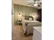 Well-lit bedroom features a cozy bed, side tables with lamps, and neutral-toned carpet at 1634 Hurdle Mills Rd, Roxboro, NC 27574