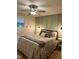 This inviting bedroom features a ceiling fan, bedside tables, and patterned bedding for a relaxing ambiance at 1634 Hurdle Mills Rd, Roxboro, NC 27574