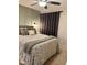 Cozy bedroom featuring a comfortable bed with patterned bedding, stylish lighting, and ceiling fan at 1634 Hurdle Mills Rd, Roxboro, NC 27574