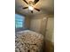 Cozy bedroom features a ceiling fan, closet and windows at 1634 Hurdle Mills Rd, Roxboro, NC 27574