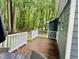 Exterior shot of wood deck with seating area surrounded by trees at 1634 Hurdle Mills Rd, Roxboro, NC 27574