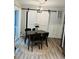Cozy dining area with a wood table, chandelier, and sliding barn door at 1634 Hurdle Mills Rd, Roxboro, NC 27574