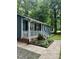 Charming home features a cozy front porch, blue siding, well-manicured landscaping and front door wreath at 1634 Hurdle Mills Rd, Roxboro, NC 27574