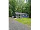 Charming home features a cozy front porch, blue siding and well-manicured landscaping at 1634 Hurdle Mills Rd, Roxboro, NC 27574