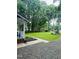 The front yard boasts of a spacious lawn, gravel driveway, and lush greenery at 1634 Hurdle Mills Rd, Roxboro, NC 27574