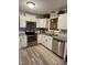 Well-lit kitchen featuring white cabinets, stainless steel appliances, and granite countertops at 1634 Hurdle Mills Rd, Roxboro, NC 27574