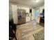 The kitchen features stainless steel appliances, white cabinets, and light wood flooring at 1634 Hurdle Mills Rd, Roxboro, NC 27574