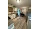 Well-equipped kitchen featuring white cabinets, stainless appliances, and adjacent dining space at 1634 Hurdle Mills Rd, Roxboro, NC 27574