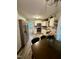 Bright kitchen with white cabinetry, stainless appliances, dining, and outdoor access at 1634 Hurdle Mills Rd, Roxboro, NC 27574