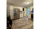 The kitchen features stainless steel appliances, white cabinets, and light wood flooring at 1634 Hurdle Mills Rd, Roxboro, NC 27574