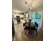 Bright kitchen features white cabinets, stainless appliances, and adjacent dining area at 1634 Hurdle Mills Rd, Roxboro, NC 27574