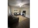 Comfortable living room with gray sofas, a stone fireplace, and modern decor at 1634 Hurdle Mills Rd, Roxboro, NC 27574
