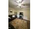 Comfortable living room features a sofa, stone fireplace, and hardwood floors at 1634 Hurdle Mills Rd, Roxboro, NC 27574