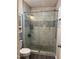 Beautifully renovated glass shower featuring marble-like tiles and modern fixtures, enhancing a spa-like experience at 1634 Hurdle Mills Rd, Roxboro, NC 27574