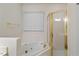 Bright bathroom featuring a soaking tub, gold fixtures, and a separate glass shower enclosure at 1703 Berwickshire Cir, Raleigh, NC 27615
