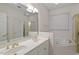 Bright bathroom with double vanity, bathtub and a separate glass shower enclosure at 1703 Berwickshire Cir, Raleigh, NC 27615