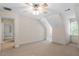 Spacious bedroom featuring neutral carpeting, a ceiling fan with light, and large window at 1703 Berwickshire Cir, Raleigh, NC 27615