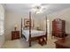 Elegant bedroom featuring a four-poster bed, decorative lamps, and classic furnishings at 1703 Berwickshire Cir, Raleigh, NC 27615
