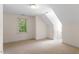 Empty bedroom with large window and slanted ceilings at 1703 Berwickshire Cir, Raleigh, NC 27615