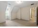 Empty bedroom with large window, carpeted floors, and entrance to hallway at 1703 Berwickshire Cir, Raleigh, NC 27615