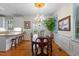 Elegant dining area featuring a chandelier, hardwood floors, and an adjacent kitchen at 1703 Berwickshire Cir, Raleigh, NC 27615