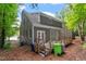 Two-story house featuring back porch, lawn, and mature trees at 1703 Berwickshire Cir, Raleigh, NC 27615