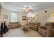 Spacious living room with a ceiling fan, neutral walls, and comfortable furniture at 1703 Berwickshire Cir, Raleigh, NC 27615