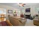 Cozy living room featuring a fireplace with built-in TV and an adjacent dining area at 1703 Berwickshire Cir, Raleigh, NC 27615