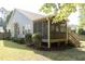 Exterior view of home showcasing back deck and landscaped backyard with garden at 1816 Piperwood Ct, Durham, NC 27713