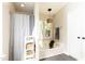 Bright bathroom showing a bathtub and shower with a privacy curtain at 1816 Piperwood Ct, Durham, NC 27713
