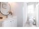 Bright bathroom features a white vanity with dual sinks and a shower-tub combo at 1816 Piperwood Ct, Durham, NC 27713