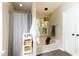 Bathroom with large tub, shower with curtain, and built in shelving at 1816 Piperwood Ct, Durham, NC 27713