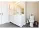 Well-lit bathroom features a double sink vanity, framed mirror, and modern fixtures at 1816 Piperwood Ct, Durham, NC 27713