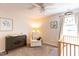 Bedroom with neutral walls, comfortable recliner, and crib by the window at 1816 Piperwood Ct, Durham, NC 27713