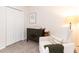 This cozy Bedroom features a comfy armchair and a classic changing table at 1816 Piperwood Ct, Durham, NC 27713