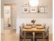 Bright dining area features modern light fixture, decorative shelving, and cozy seating for four at 1816 Piperwood Ct, Durham, NC 27713