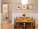Elegant dining room with a wooden table setting, decorative wall art, and modern lighting at 1816 Piperwood Ct, Durham, NC 27713