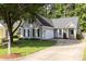 Charming home with gray siding, mature tree, and well-manicured lawn and driveway at 1816 Piperwood Ct, Durham, NC 27713