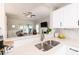 The kitchen has stainless steel sink and faucet, and opens into the living room space at 1816 Piperwood Ct, Durham, NC 27713