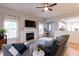 Inviting living room featuring hardwood floors, a fireplace, and large windows with curtains at 1816 Piperwood Ct, Durham, NC 27713