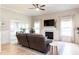 Comfortable living room boasts a fireplace, recessed lighting, and opens to additional living spaces at 1816 Piperwood Ct, Durham, NC 27713