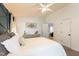 Bright main bedroom featuring a ceiling fan, gray dresser, and doorway at 1816 Piperwood Ct, Durham, NC 27713