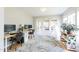 Bright home office with multiple work spaces, natural light, and a decorative rug at 1816 Piperwood Ct, Durham, NC 27713