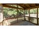 Large, screened porch with wood floors and backyard views at 1816 Piperwood Ct, Durham, NC 27713
