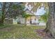 Charming home backyard with beautiful trees, patio with string lights, and firepit at 1917 Washington St, Durham, NC 27704
