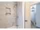 Beautiful bathroom featuring shower with marble look tile and built-in shelving at 1917 Washington St, Durham, NC 27704